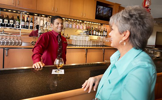 Bartender serving a customer at a bar